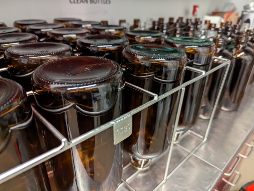 bottle in a stainless tray ready for rinsing