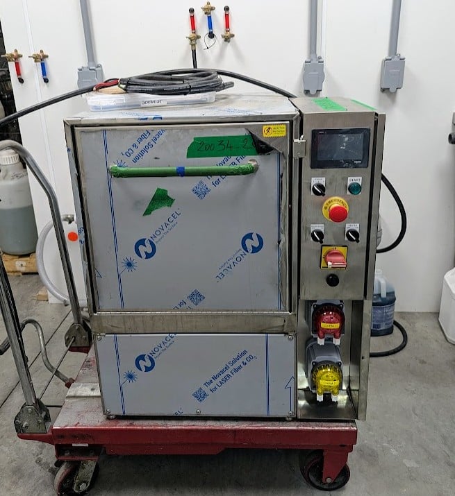 Wine bottle rinser removing shipping residue from new wine bottles before filling